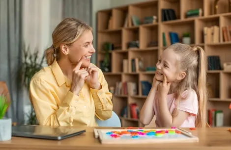 Psychologist taking notes during a child therapy session at PCBH